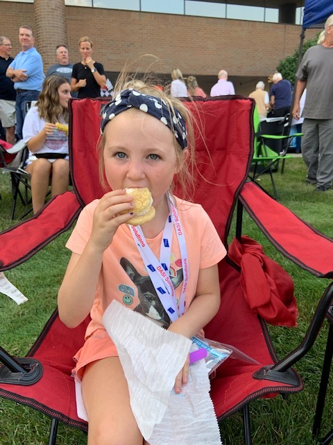 Close of girl eating ice cream blue headband on.jpg